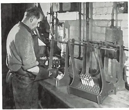 Picture12 A man arranges objects on weighing scales in an industrial or laboratory setting.