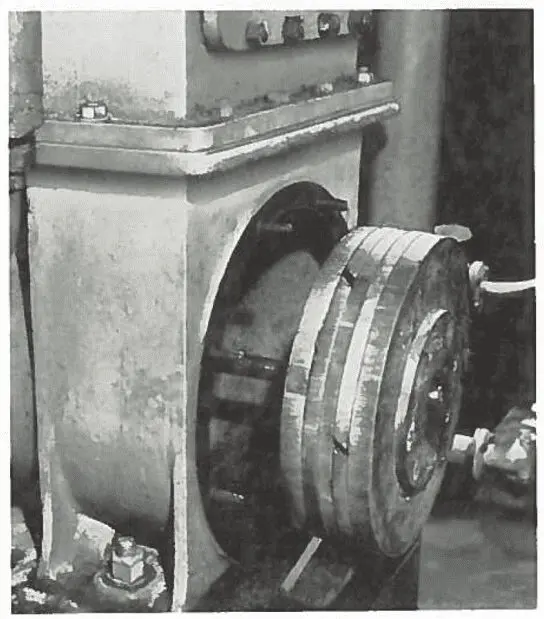 Close-up of industrial machinery featuring a circular metal component mounted on a rectangular base.