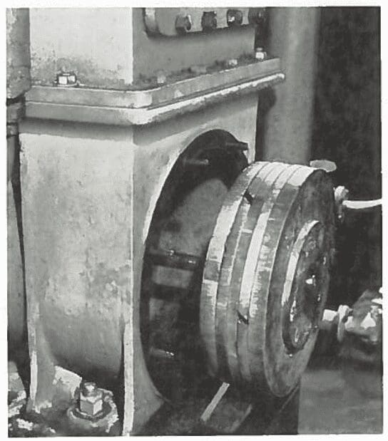 Close-up of industrial machinery featuring a circular metal component mounted on a rectangular base.